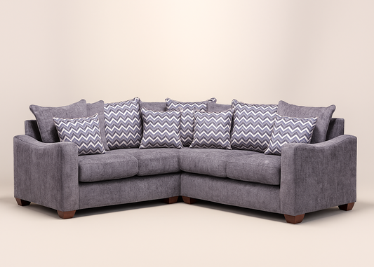 Gray sectional sofa with zigzag patterned cushions on a beige background