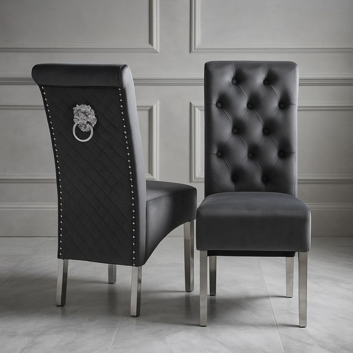 Two black upholstered chairs with silver legs on a gray floor.