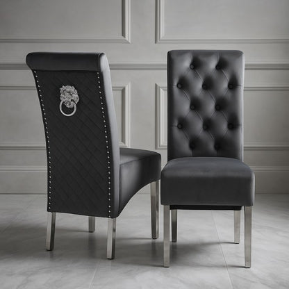 Two black upholstered chairs with silver legs on a gray floor.